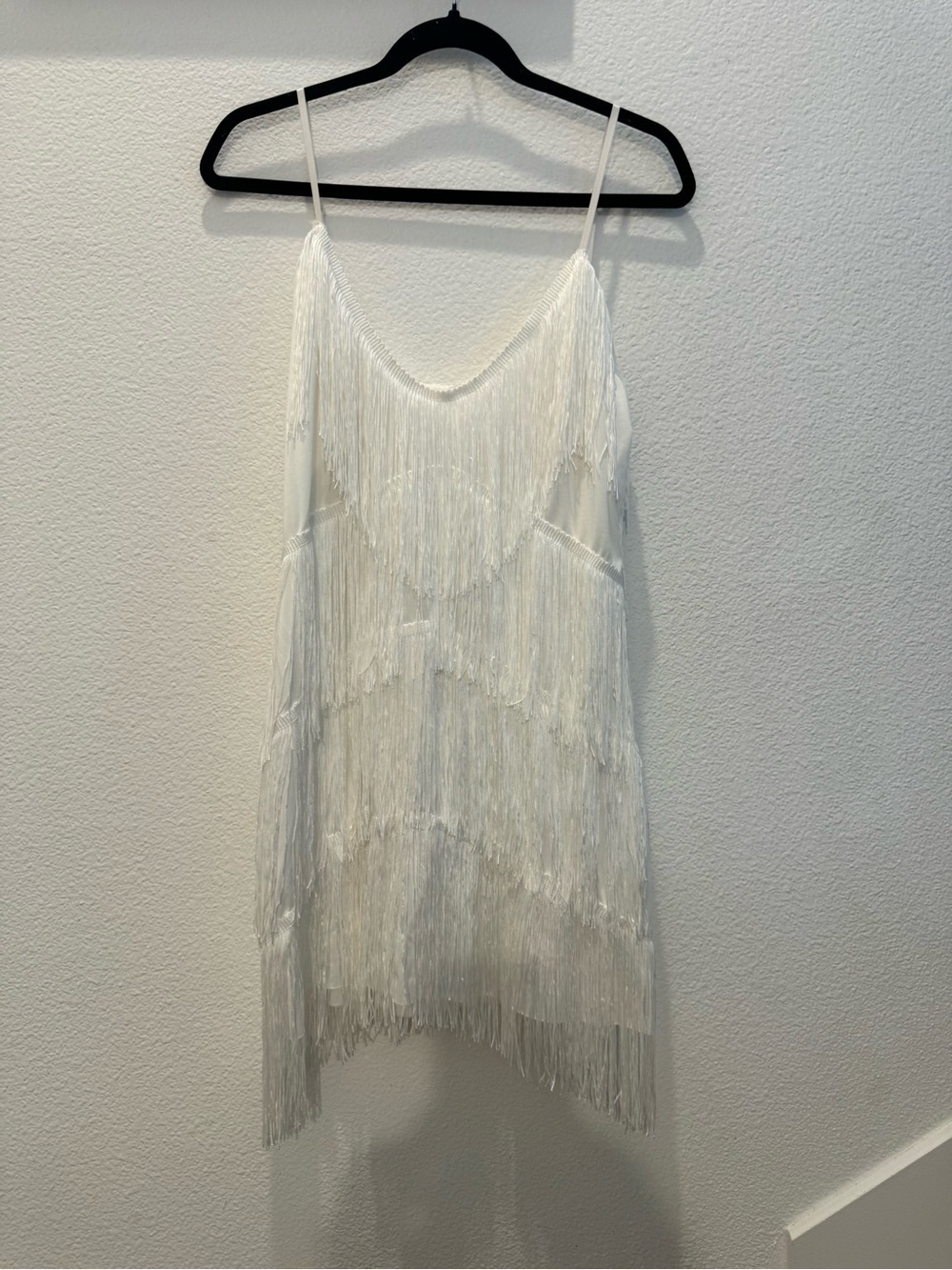 Spaghetti-strap mini dress w/ layered fringe detail that moves effortlessly